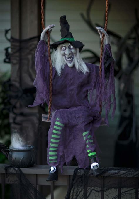 Incorporating swinging witch decorations into a haunted house attraction